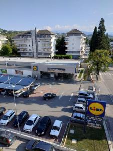 a parking lot with cars parked in front of a building at Novatek Apartment B&B in Chieti