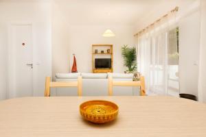 a room with a table with a bowl on top of it at Villas Boas House Caparica in Costa da Caparica