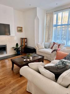 a living room with two couches and a coffee table at Spacious Belsize Park apartment close to station in London