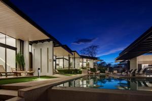 an external view of a house with a swimming pool at Epic Tamarindo Boutique Hotel in Villarreal