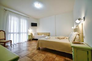 Olimpo B&B في جوردينيانو: غرفة نوم بسرير واريكة في غرفة