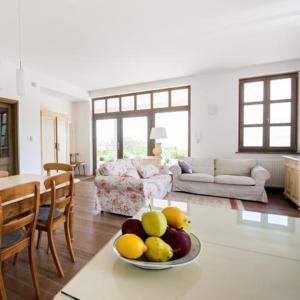 a living room with a bowl of fruit on a table at Villa Portico in Badacsonytomaj