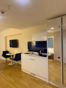 a room with a kitchen with a table and a bedroom at ORBI CITY - Batumi Apartments in Batumi