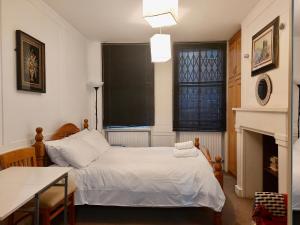 a bedroom with a bed and a fireplace at Stay in Bloomsbury2 in London