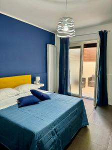 a blue bedroom with a bed with a blue wall at IL RUGGI BB in Salerno