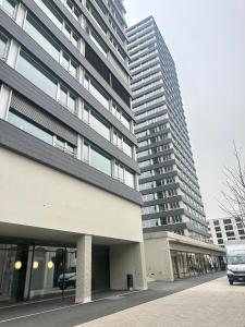 a building with two tall buildings next to a street at 2.5 Room@MydiHei Apartments in Neuhausen am Rheinfall