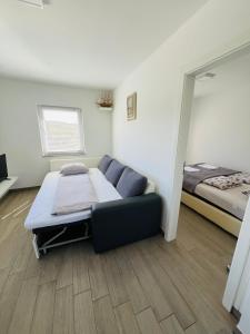 a room with a couch and a bed in it at Apartments Jagodje in Izola