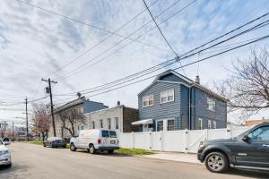 a blue house on the side of a street at Updated Linden Home Visit NYC and Newark! in Linden