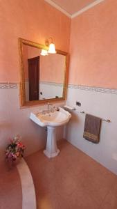 a bathroom with a sink and a mirror at Guest Room Perla Marina in Augusta