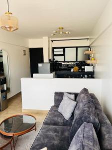 a living room with a couch and a table at Cozy one bedroom duplex apartment in kinoo in Nairobi