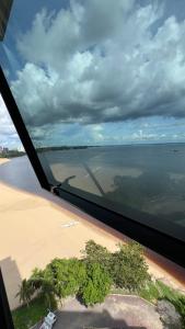 a view of a beach and the ocean from an airplane at Flat no Condomínio do Edifício Tropical Executive e residence com Vista para o Rio in Manaus