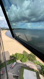 a view of a beach and the ocean from an airplane at Flat no Condomínio do Edifício Tropical Executive e residence com Vista para o Rio in Manaus