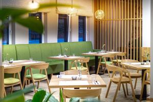 a row of tables and chairs in a restaurant at NOVY Hotel in Zielona Góra +67 photos