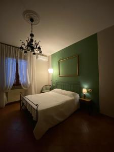 a bedroom with a large bed with blue curtains at Affittacamere B&B Caorso in Caorso