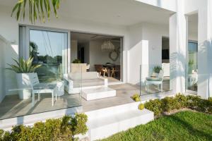 a living room with white furniture on a house at Palm Cay Marina and Resort in Nassau