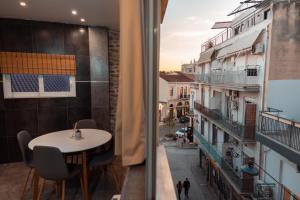 a room with a table and a view of a building at Parthenon Portrait Apartments in Athens