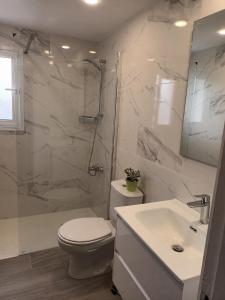 a bathroom with a toilet and a shower and a sink at Ocean Blue Apartments in Paphos +47 photos