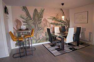 un comedor con mesa, sillas y un mural en Fee4Me Bilbao, Style and Comfort, en Bilbao