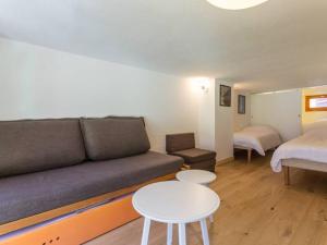 a living room with a couch and a bed and a table at Appartement Les Arcs 1800, 2 pièces, 6 personnes - FR-1-346-402 in Arc 1800