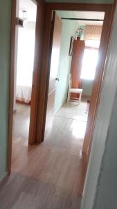 a hallway with a door and a chair in a room at Apartamento playa Muchavista in El Campello