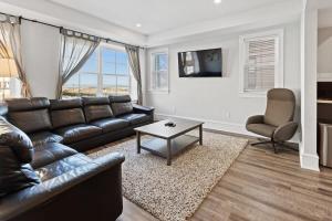 a living room with a leather couch and a table at Modern 4BR 2BA Apt Steps to the Beach Open Living in Atlantic City