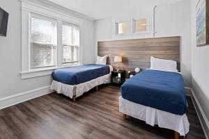 a bedroom with two beds and a window at Modern 4BR 2BA Apt Steps to the Beach Open Living in Atlantic City