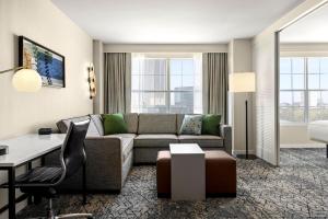 a living room with a couch and a table at Sheraton Suites Galleria Atlanta in Atlanta