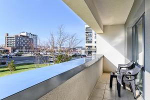 two chairs on a balcony with a view of a city at JAD Luxury Apartments Kasper in Braşov