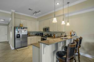 a kitchen with a refrigerator and a counter top at Water front Getaway w. Boat Docks / Fishing in Orange Beach