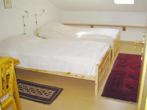 two bunk beds in a room with a rug at Ferienhaus Knittel Verm nur Samstag auf Samstag in Murnau am Staffelsee