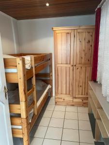 a room with two bunk beds and a cabinet at Zur Fellnase in Horka