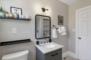 a bathroom with a sink and a mirror at Forest Acres Boho Home - 2BR in Columbia +20 photos