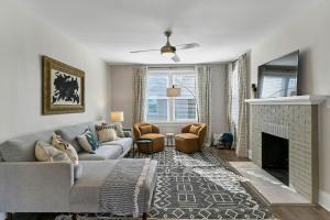 a living room with a couch and a fireplace at Forest Acres Boho Home - 2BR in Columbia
