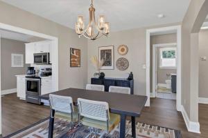 a kitchen and dining room with a table and chairs at Forest Acres Boho Home - 2BR in Columbia