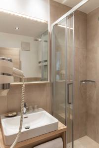 a bathroom with a sink and a shower at Gasthof "zur Bahn" in Lassnitzhöhe