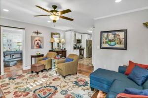 a living room with a blue couch and a kitchen at 2BR Cottage - Minutes from USC in Columbia