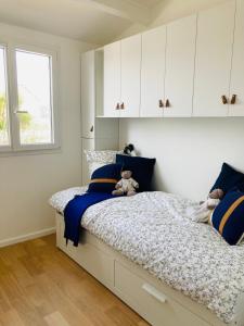 a bedroom with a bed with two teddy bears on it at MAZET RÉNOVE Golfe de st TROPEZ in Cogolin