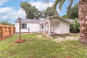 a small white house in a yard with a palm tree at Prospect Place - 2BR 1 BA in Columbia