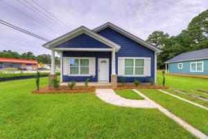 a blue house with a green lawn at Cayce Sister Houses-Sleeps 14 in Cayce