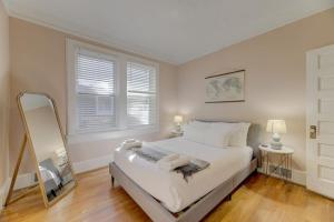 a bedroom with a large bed and a mirror at Rose Hill Retreat-Mins to USC in Columbia