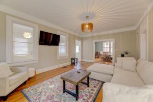 a living room with white couches and a coffee table at Rose Hill Retreat-Mins to USC in Columbia