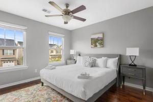 a bedroom with a white bed and a ceiling fan at Contemporary 3BR in Columbia