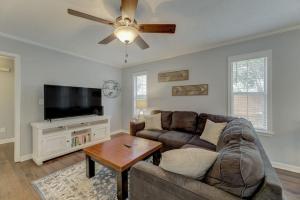 a living room with a couch and a flat screen tv at Lexington Home Near Main St in Lexington
