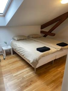 a bedroom with a large bed with a wooden floor at Private Rom for two in Oslo City center-Main Street-Walking distance in Oslo