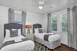 a bedroom with two beds and a ceiling fan at Modern Gem in Columbia in Columbia