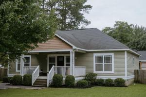 a small house with a white porch and stairs at The Congaree Cottage in Cayce