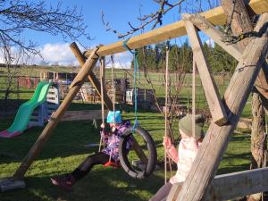 two children playing on a swing set at Privat Sabaka - Chalupa pod Kriváňom vo Východnej in Východná