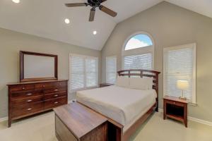 a bedroom with a bed and a dresser and windows at Trendy Columbia Townhome in Columbia