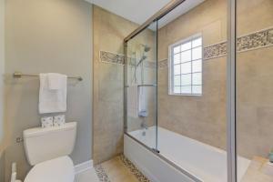 a bathroom with a toilet and a glass shower at Trendy Columbia Townhome in Columbia +26 photos