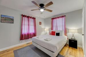 a bedroom with a bed and a ceiling fan at Updated Columbian Cottage in Columbia